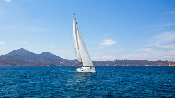 istock Sailing ship luxury yacht with white sails in the Sea. 1013850892