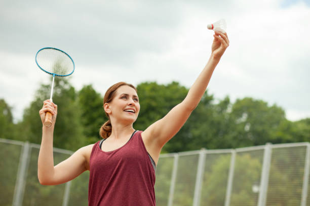 attractive 30 year old woman playing badminton stock photo