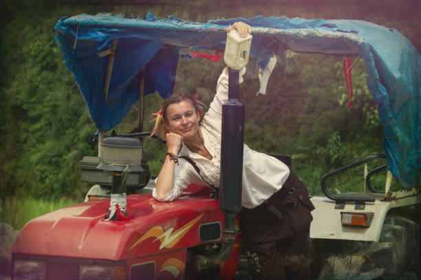 istock Young Woman Farmer on red tractor 1013853232