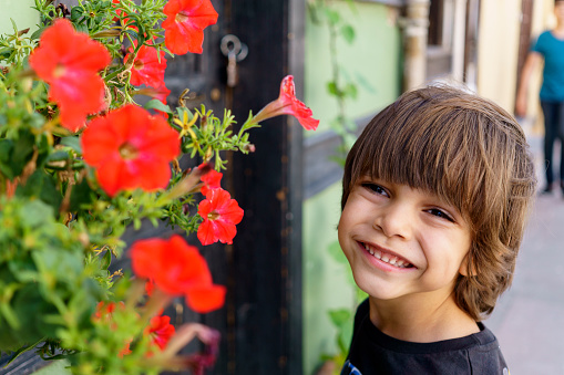 child smiling with flowers