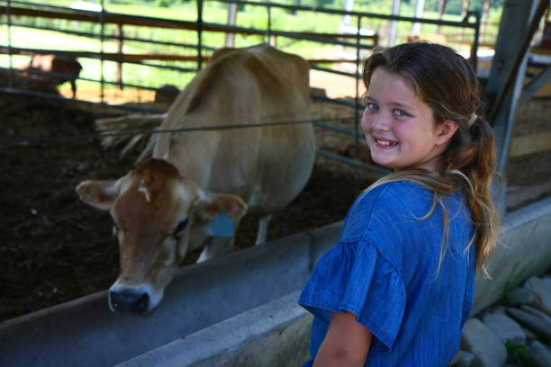 istock Young Girl With A Cow 1013857914