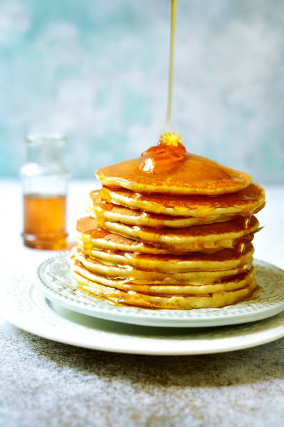 istock Stack of homemade delicious pancakes with maple syrup for a breakfast 1013869910