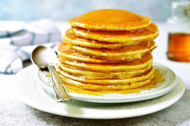 istock Stack of homemade delicious pancakes with maple syrup for a breakfast 1013869980
