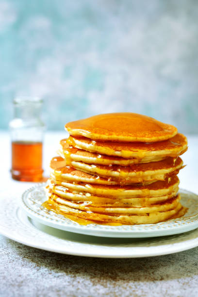 istock Stack of homemade delicious pancakes with maple syrup for a breakfast 1013869982