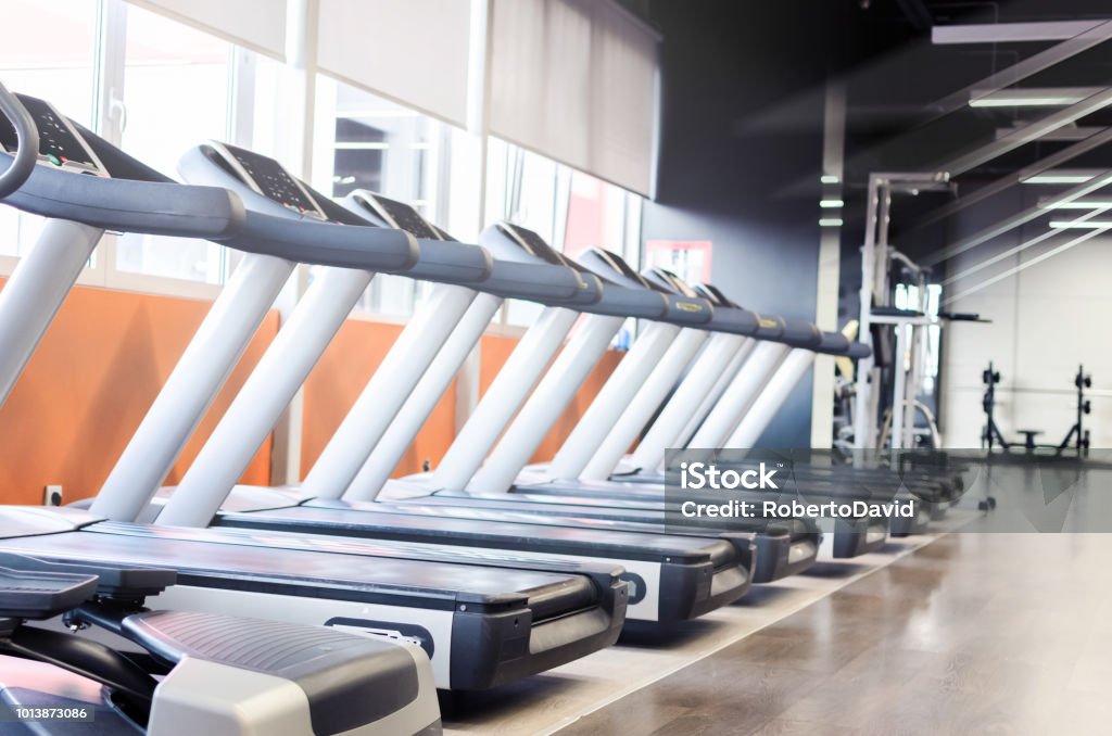 Image of multi treadmills Image of empty gym and treadmills in it. Gym Stock Photo