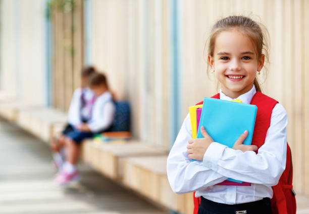 istock Happy children  girlfriend schoolgirl student elementary school 1013873906