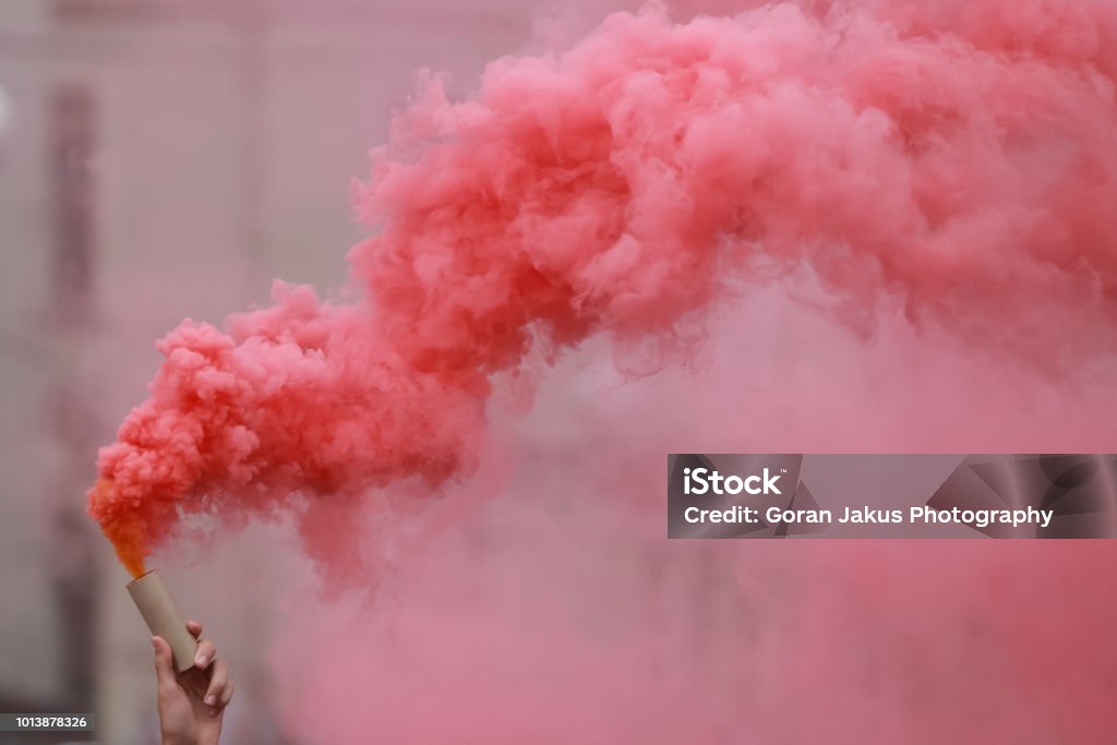 Red hand flare A man holding a hand flare with red smoke. Smoke - Physical Structure Stock Photo