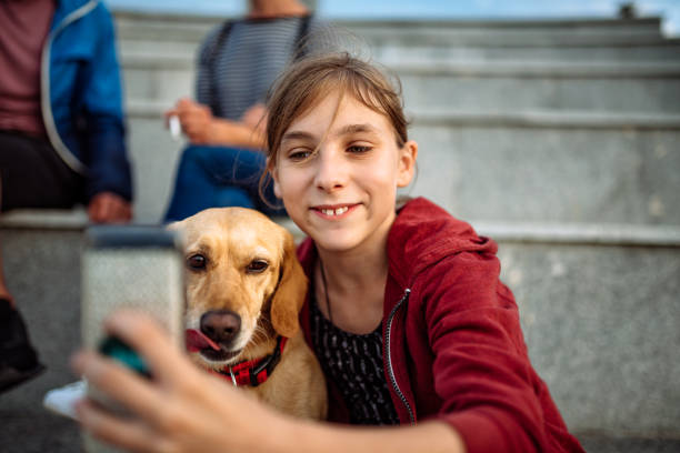istock Girl and her dog taking selfie 1013878404