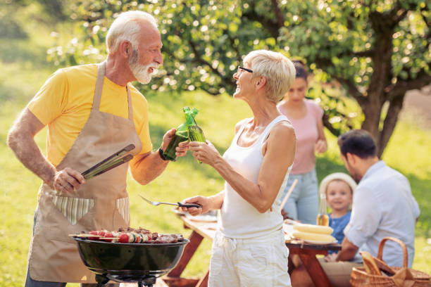 istock Family having a barbecue in a park 1013878700