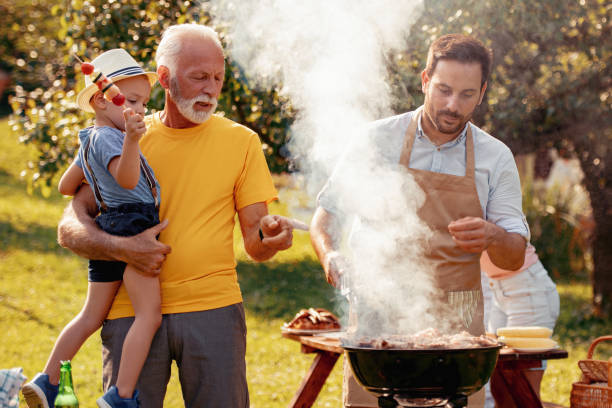 istock Family having a barbecue in a park 1013881330