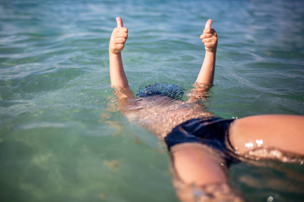 istock Little boy enjoying by the sea 1013884054