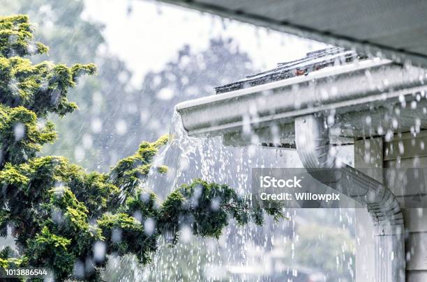 Torrential Summer Rain Storm Water Overflowing Roof Gutters Stock Photo - Download Image Now