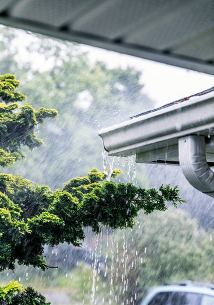 istock Summer Rain Storm Water Overflowing Roof Gutter 1013886656
