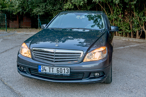 Istanbul, Turkey, 1 August 2018: Front view of car with mercedes benz star and headlights on.