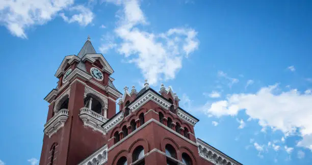 A low-angle view of a gothic style brick courthouse in Wilmington, NC, USA.
