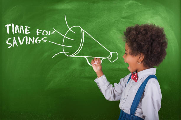 istock School child scream megaphone near school blackboard. 1013901168