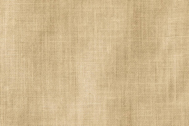 istock Hessian sackcloth woven texture pattern background in light cream yellow beige earth tone color 1013913470