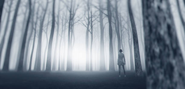 istock Lost woman standing in forest at night 1013914372