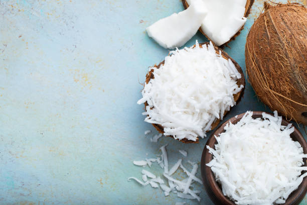 istock Coconut flakes in a shell on a blue background. top view with copy space 1013923990