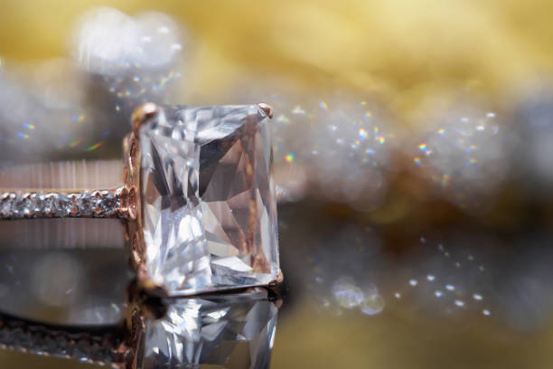 istock Luxury Jewelry diamond and pink topaz ring with reflection on black background 1013929096