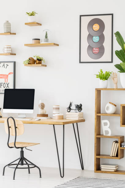 istock Chair at desk with computer desktop in bright workspace interior with records and plant. Real photo 1013931480
