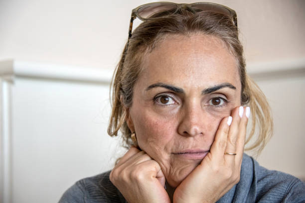 Concerned serious mature hispanic or middle eastern woman looking at the camera concerned