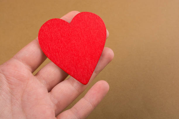 istock Red color heart shaped object in hand 1013942224