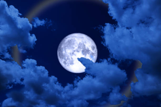 istock full blue moon halo, moon and colorful ray back night cloud 1013942994