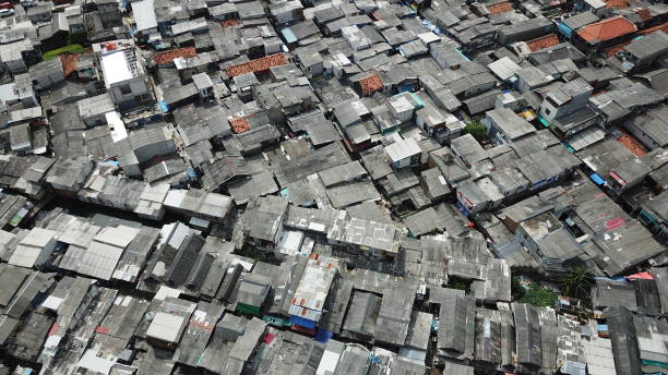 Aerial view of crowded slum neighborhood Aerial view of crowded slum neighborhood on the lakeside at North Jakarta, Indonesia jakarta slums stock pictures, royalty-free photos & images