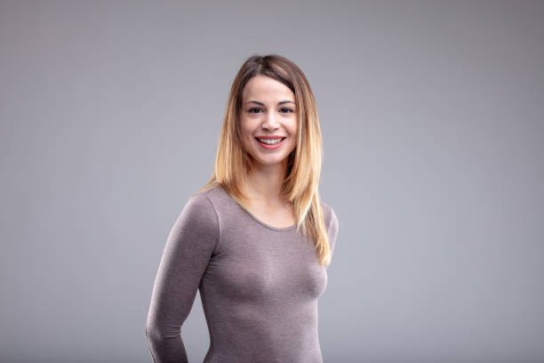 istock Happy woman in grey shirt looking at camera 1013961014