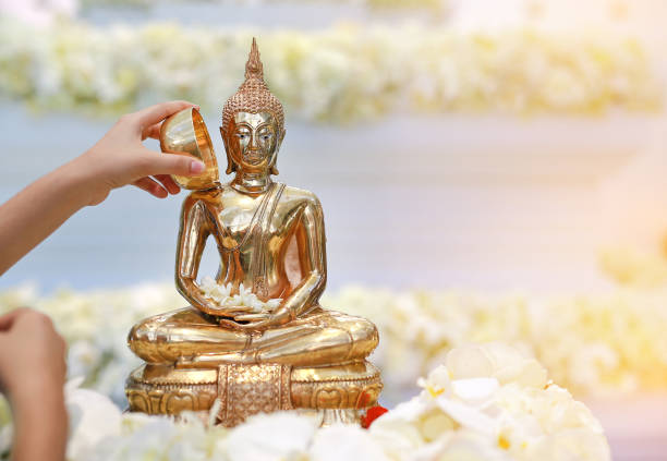 istock People blessing holy water and pay respects to Buddha statue. 1013961414