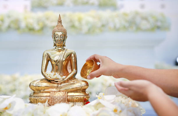 istock People blessing holy water and pay respects to Buddha statue. 1013961426