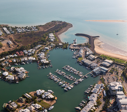 An aerial photo of Cullen Bay, Darwin, Northern Territory, Australia showing marina, residential area and rock wall