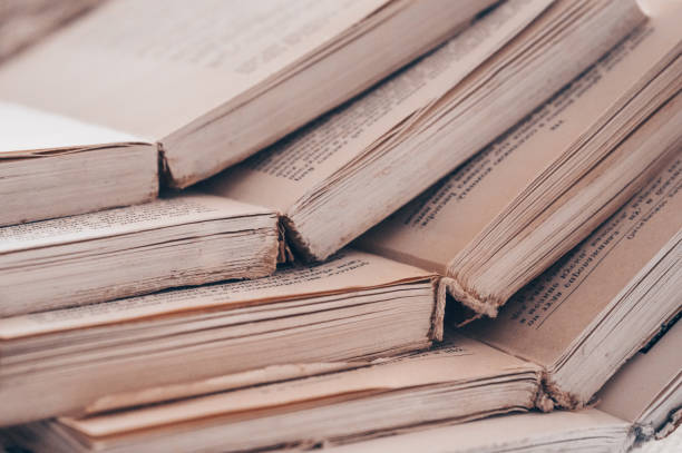 istock Chaotic stack of old books pastel colors, selective focus with copy space. Background from books. Books close up. 1013971840