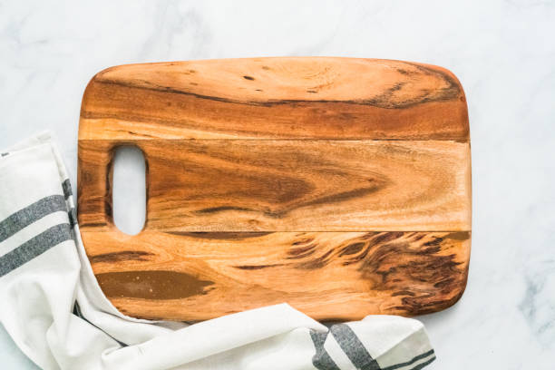 istock Rustic wood cutting board on marble countertop. 1013977106