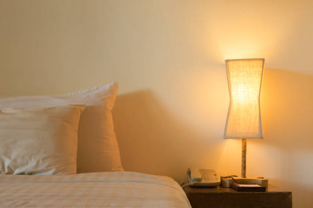 istock Asia tropical hotel interior with bedroom setting including bedside table with lamp 1013988694