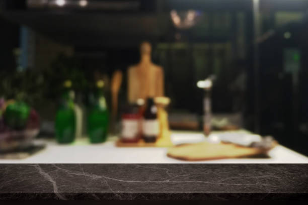 istock Empty black stone table top and blurred kitchen interior background - can used for display or montage your products. 1013994180