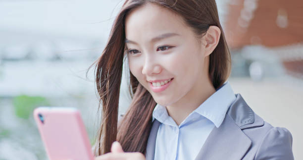 istock business woman use phone 1014005436