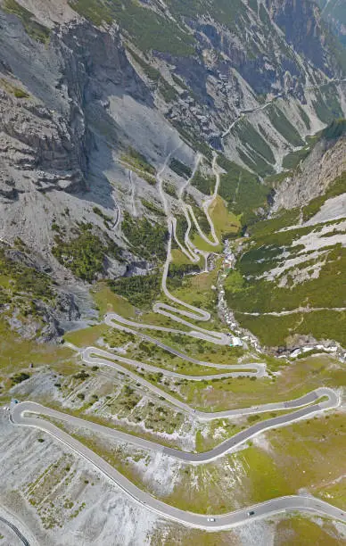 Photo of Road to the Stelvio mountain pass in Italy. Amazing aerial view of the mountain bends creating beautiful shapes