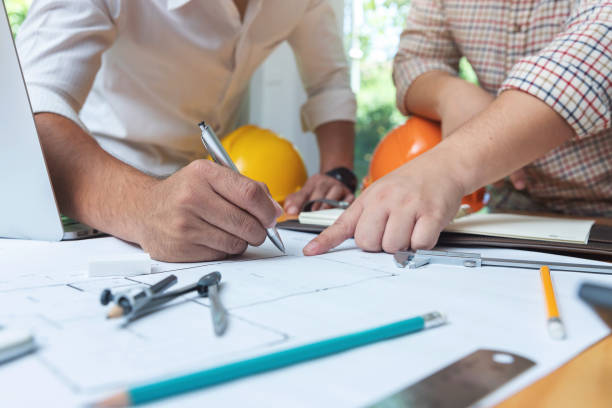istock Engineer and Architect concept, Engineer Architects and real estate agent office team working with blueprints 1014011892