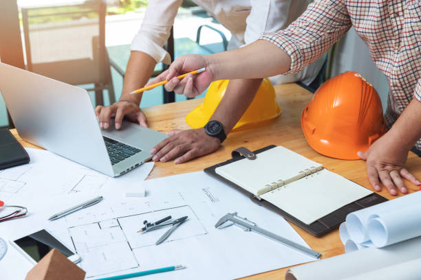 istock Engineer and Architect concept, Engineer Architects and real estate agent office team working with blueprints 1014011988