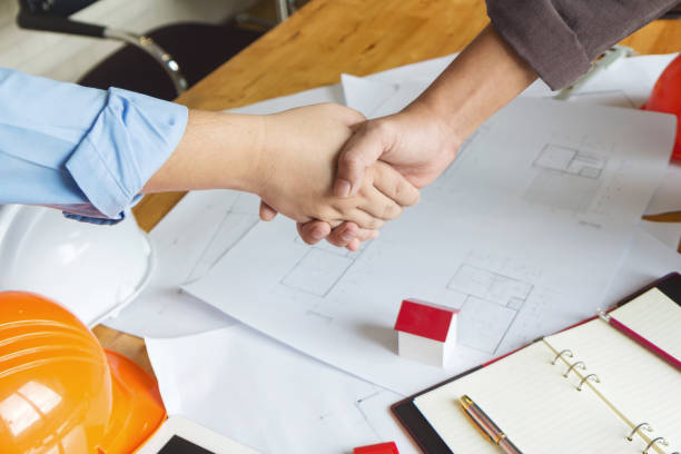 istock Engineer and Architect concept, Engineer Architects and real estate agent office team working with blueprints 1014022766
