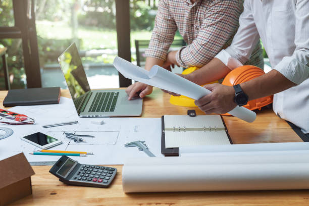istock Engineer and Architect concept, Engineer Architects and real estate agent office team working with blueprints 1014022776