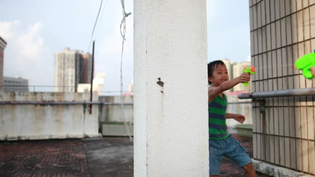 Children playing with squirt gun