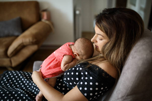 istock Baby sleeping in  mother's arms 1014025992