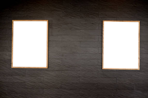 istock Two blank picture frames against a black textured interior wall 1014031674