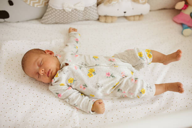 istock Cute baby girl sleeping in a crib 1014040476