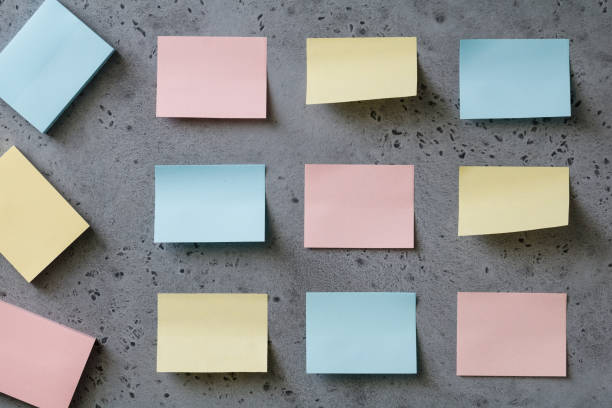 istock Colorful empty sticky notes on a grey textured background. The concept organization and planning. 1014040480