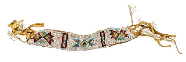 Photo of Old Indian bracelet as jewelry / bead weaving sewn on leather optionally placed on white