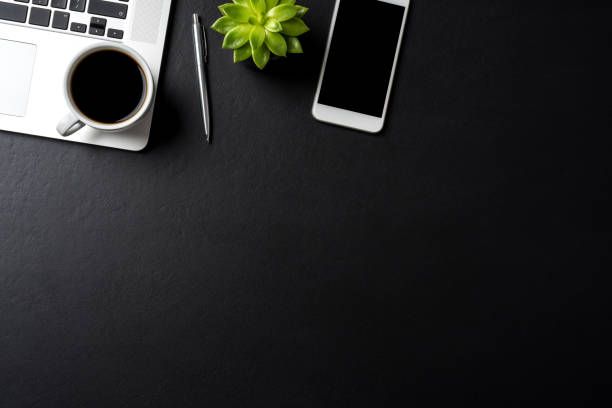 istock Elegant black office desktop with laptop and accessories. Copy space 1014047532